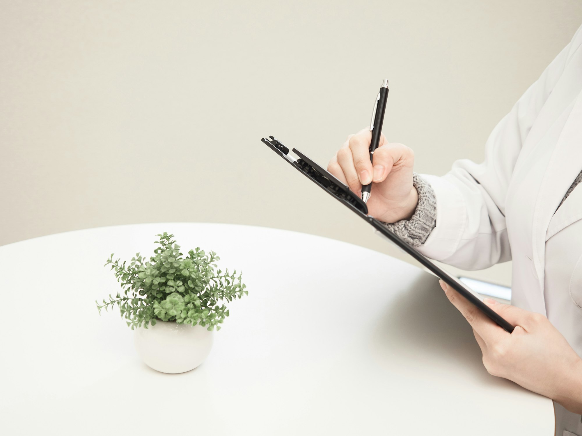 Therapist taking notes during a counseling session
