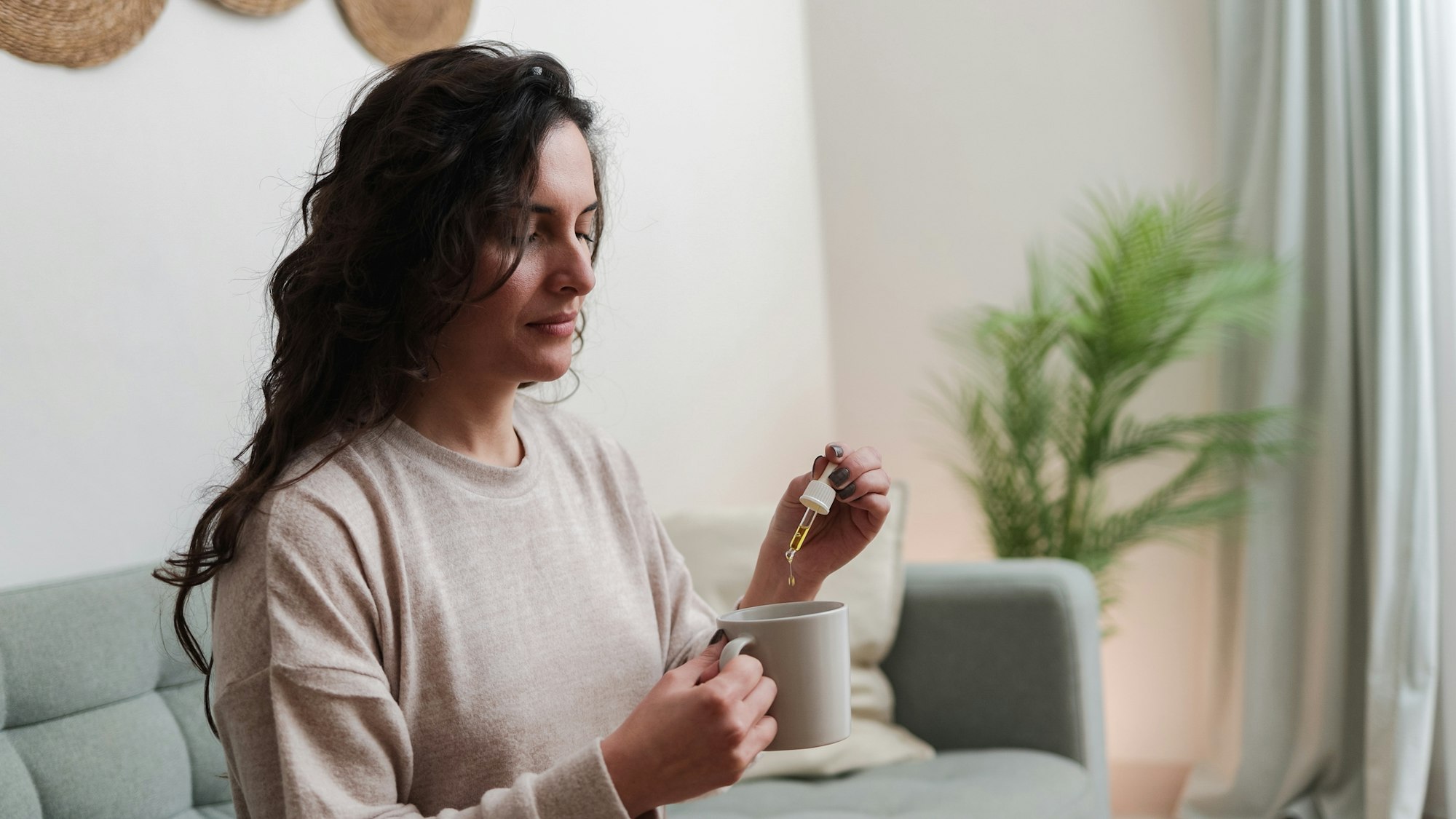 Woman taking cbd oil for anxiety treatment - Vitamins and supplements